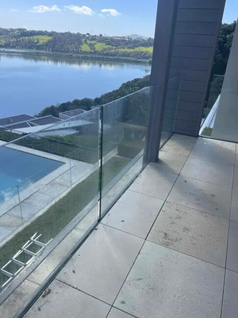 Balcony tiles and glass balustrade: before