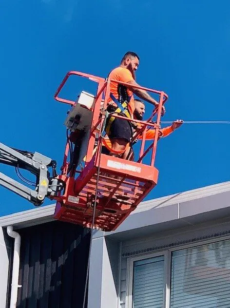WashNZ crew washing a townhouse from an elevated work platform