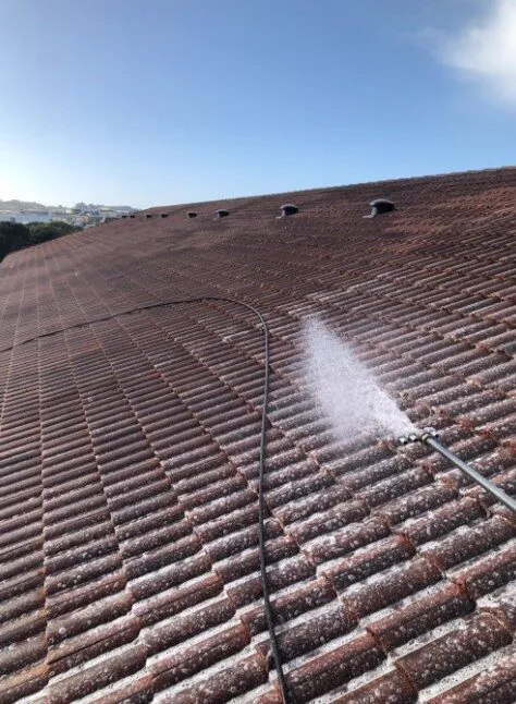 Low-pressure roof treatment in progress