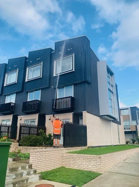 Ground crew washing a townhouse block